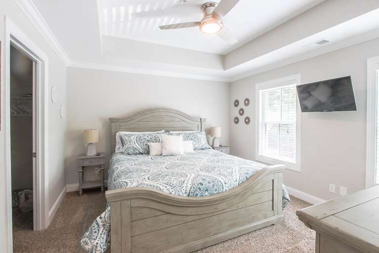 Bedroom 1 with king bed and mounted tv