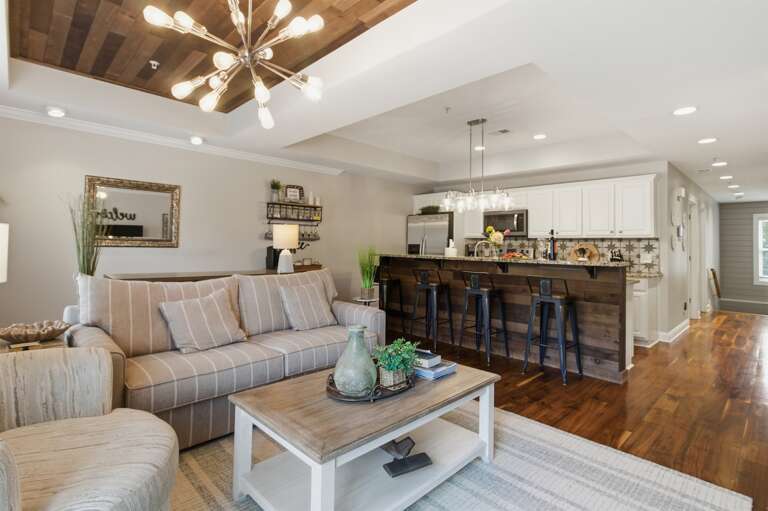 Spacious living area connected to a modern kitchen, perfect for gathering and relaxing.