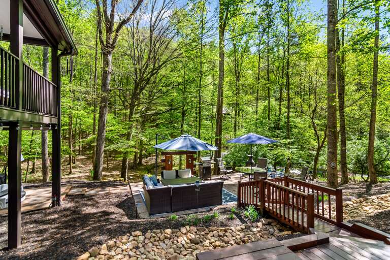 Lounging patio that faces the stream and fire pit!