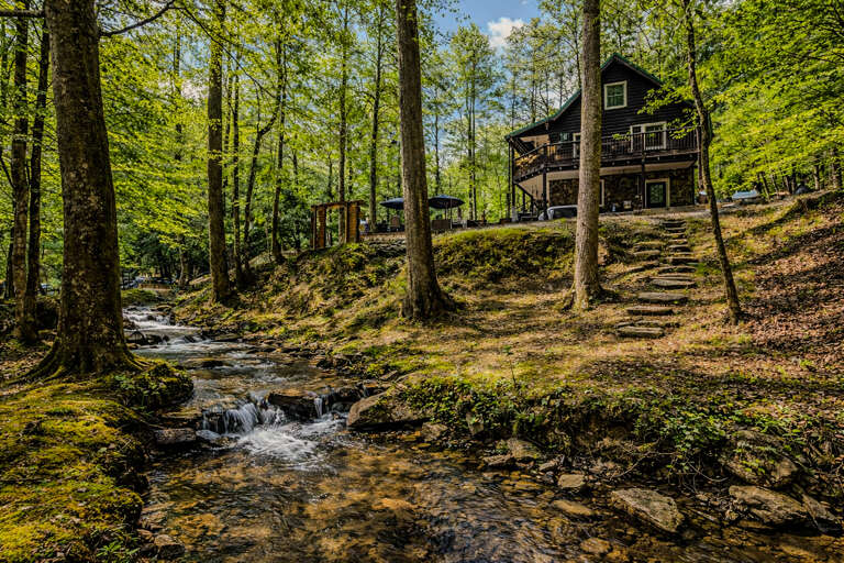 A serene waterfront retreat with stream views. Perfect for rest, restoration, and meaningful moments.