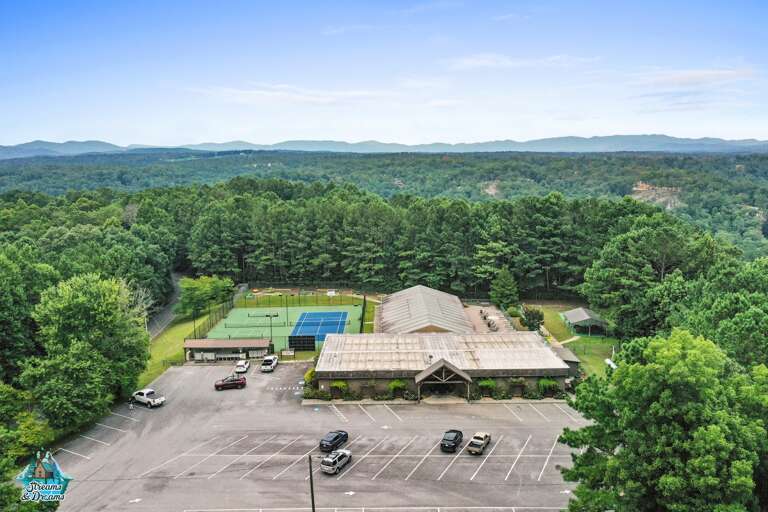 Views of the tennis courts, indoor pool facility, building that hosts the game room, gym, and shower facility.