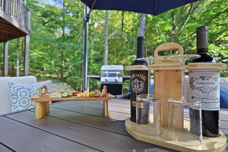 Outdoor lounging on patio in filtered sunlight to enjoy nature, water, and your favorite vino!