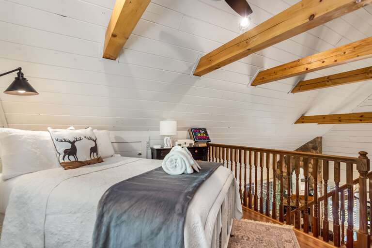 Exposed beams with views of the water or down below of the cottage!