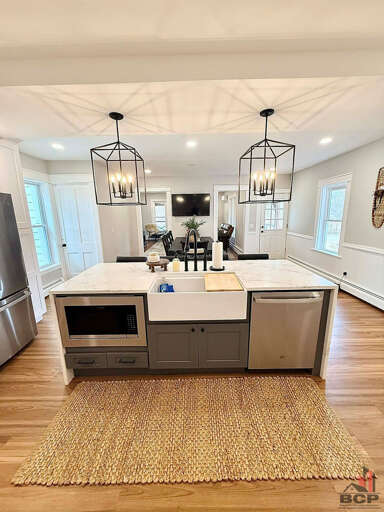 Built-in microwave, farmhouse sink, and dishwasher