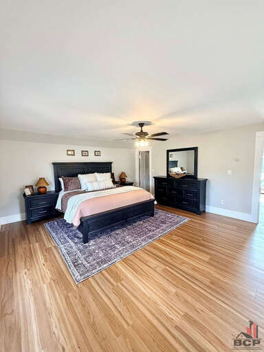 Second primary w/ king size bed, dresser, and Smart TV