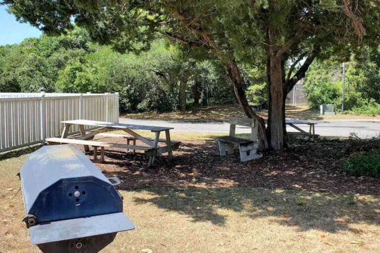 Picnic area with grill next to smaller pool