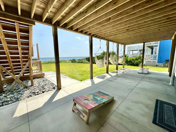 Oceanfront patio with corn hole game
