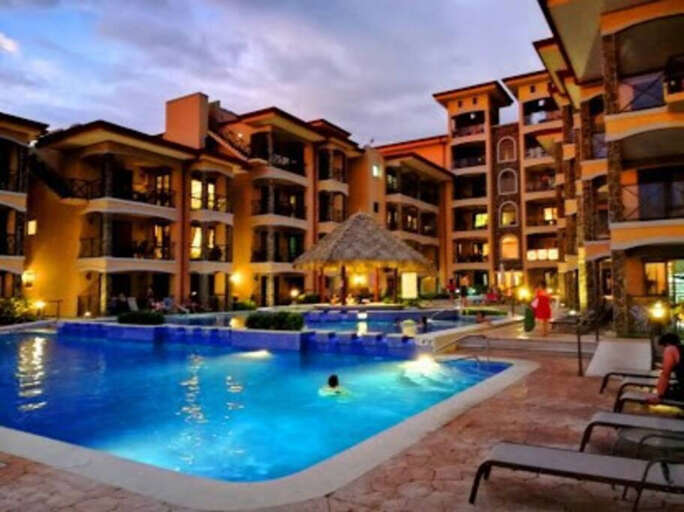 Complex at night with 3-tier pool.