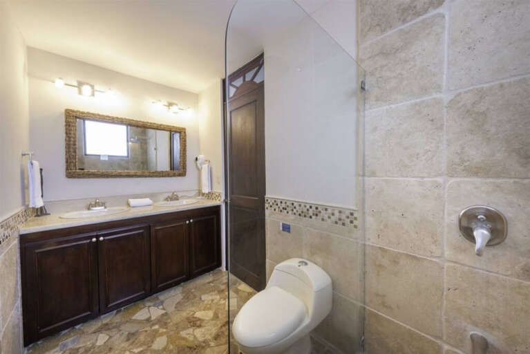 Double vanity master bath with granite and tile finishes.