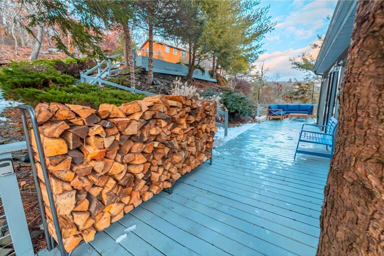 Blue Boardwalk Beside Stacked Stone Structure Under Sunset Sky