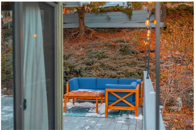 Outdoor Seating With Blue Bench Beside A Wooden Table, Surrounded By Bare Shrubs And Autumnal Ambiance