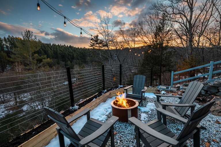 Outdoor Seating With Fire Pit Overlooking Wooded Vista At Sunset