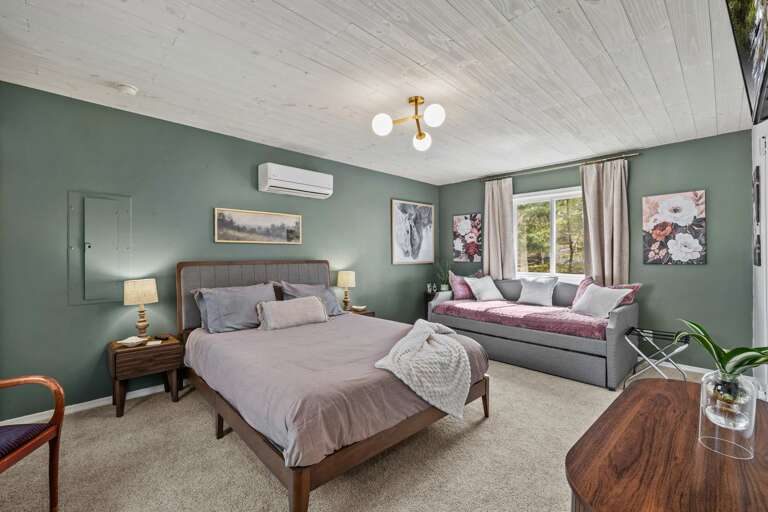 Plush Pillows On Beds In A Pristine Painted Room With Peaceful Panorama