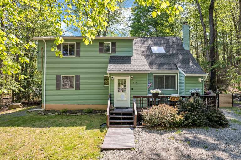 Two-story Green Vacation Rental Amidst Lush Trees