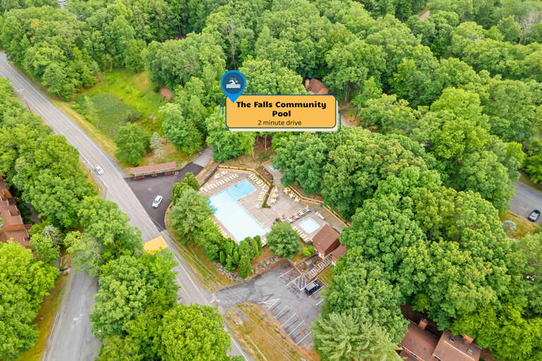 Aerial View Of A Community Pool Surrounded By Lush, Leafy Trees