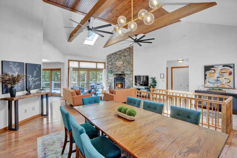 Spacious Room With Skylights, Stone Fireplace, And A Large Dining Table