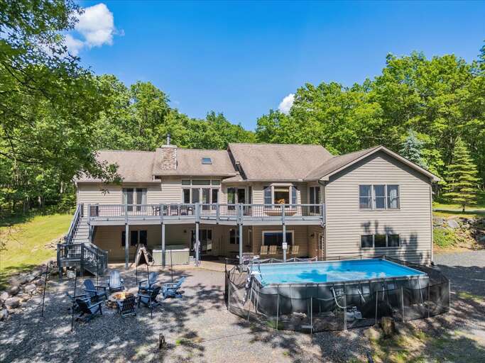 Large Multi-level Building With Pool Nestled Among Trees