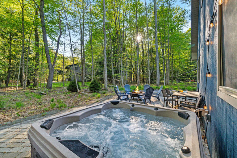 Vacation Rental With Bubbling Hot Tub And Dining Area Nestled Among Vibrant, Verdant Trees