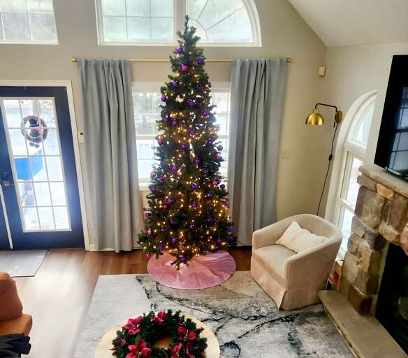 Living Space With Large Christmas Tree And Fireplace, Festive Decorations Visible