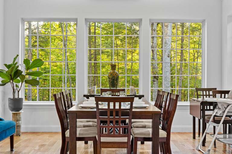 Dining Area With Large Windows And Forest View