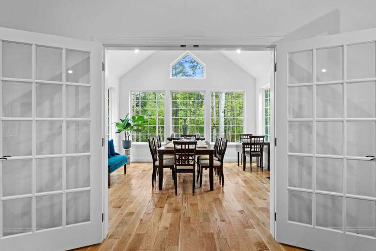 Open French Doors, Dining Table, Sunlit Windows, Lush Greenery View