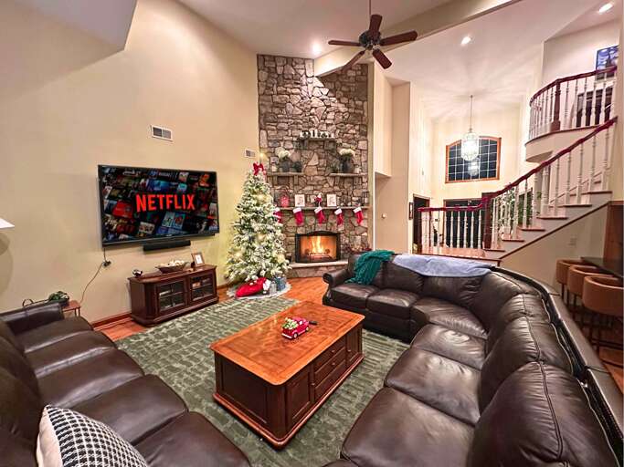 Spacious Living Room With Sectional Sofa, Fireplace, And Festive Decorations In Vacation Rental