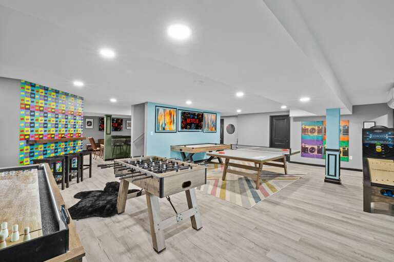 Spacious Indoor Recreation Room With Games And Vibrant Wall Art