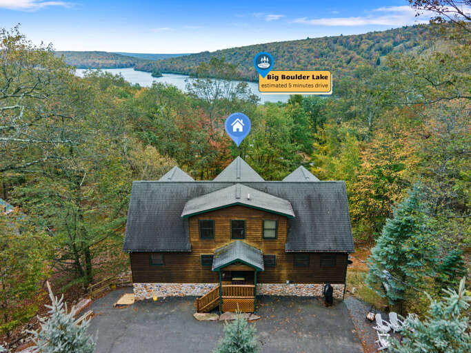 Large Log Structure Surrounded By Trees Overlooking A Distant Lake