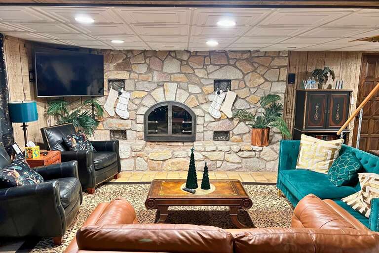 Stone-walled Sitting Space With Leather Seats And Television