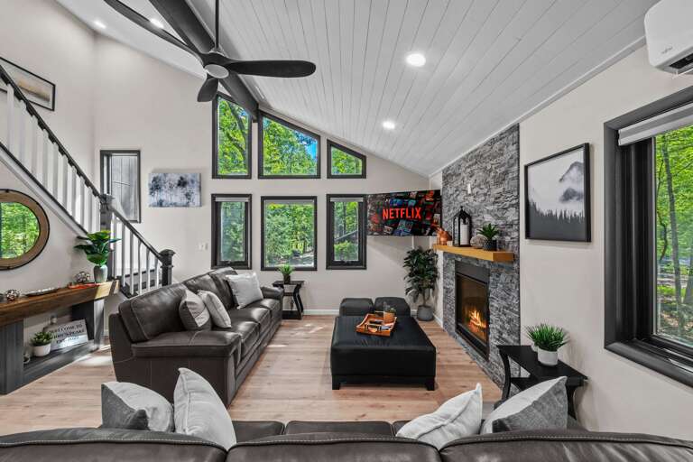 Spacious Living Room, Large Windows, Stone Fireplace, Plush Seating