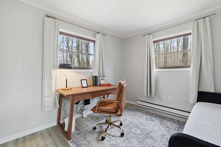 Bright Room With Desk, Chair, And Two Windows