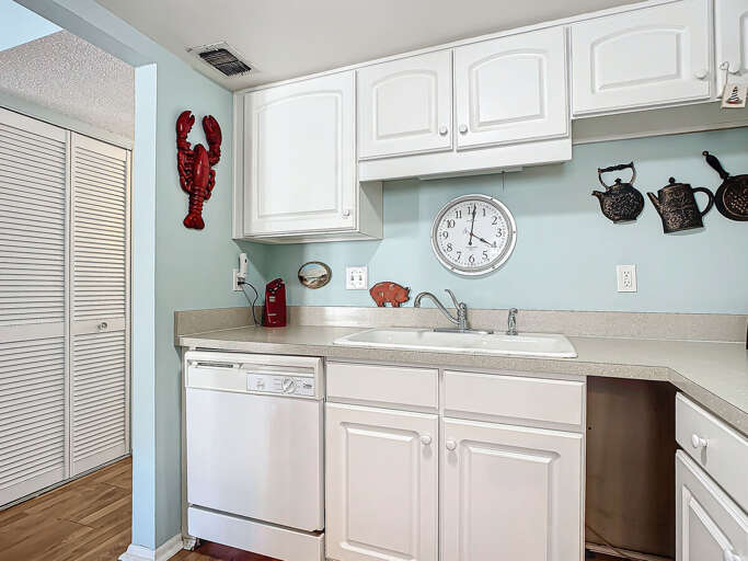 A delightful kitchen with playful wall decor and a welcoming ambiance for culinary adventures.