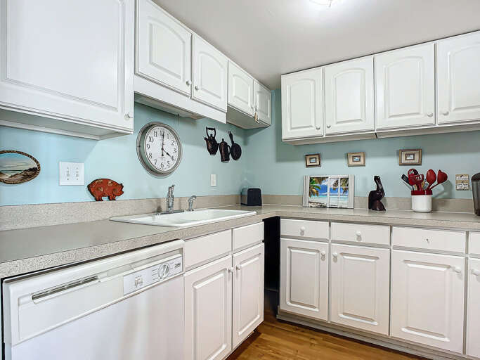 Prepare meals in a fully equipped kitchen with plenty of counter space and stylish white cabinetry.