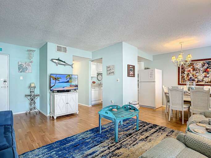 Relax with a beachy vibe in this cozy living room with ample seating and a large TV.