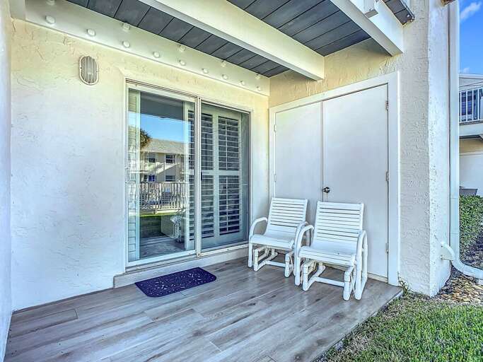 Relax on the private patio with comfortable seating, offering easy access to the outdoors.