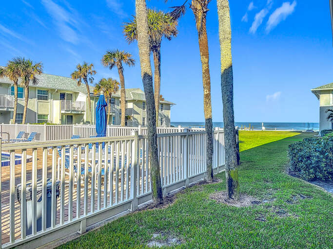 Savor the ocean breeze with a clear view of palm trees and the beach.