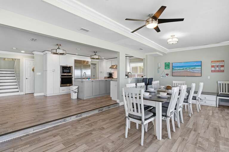 Gather in this spacious dining area connected to a modern kitchen and open living space. Perfect for