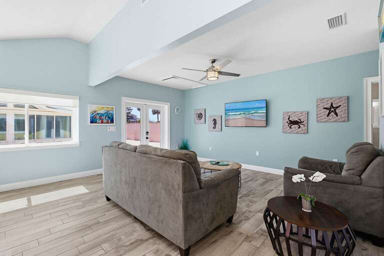Kick back in this spacious living room featuring coastal décor, comfy seating, and plenty of