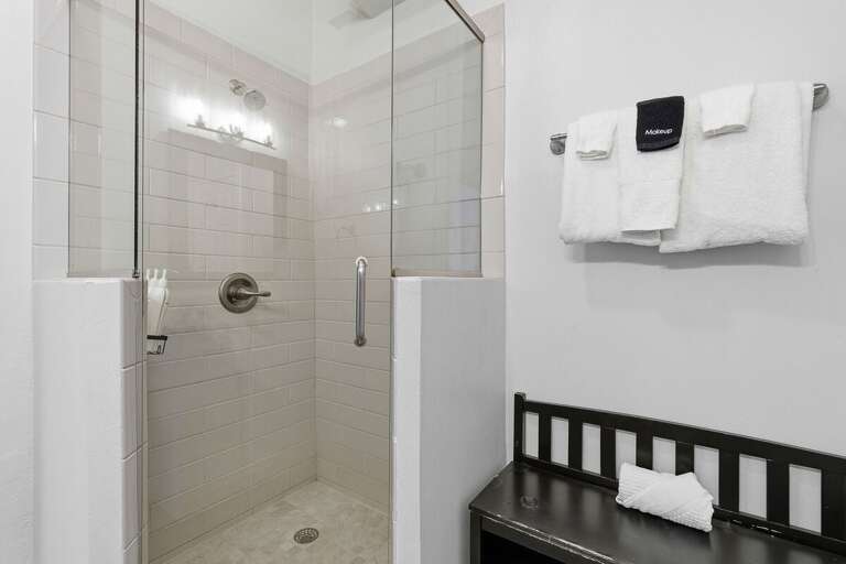 Refresh in this modern walk-in shower featuring sleek tile and bright finishes. Perfect for your beach stay, rinse off after a day in the sun and enjoy a clean, comfortable space to recharge.