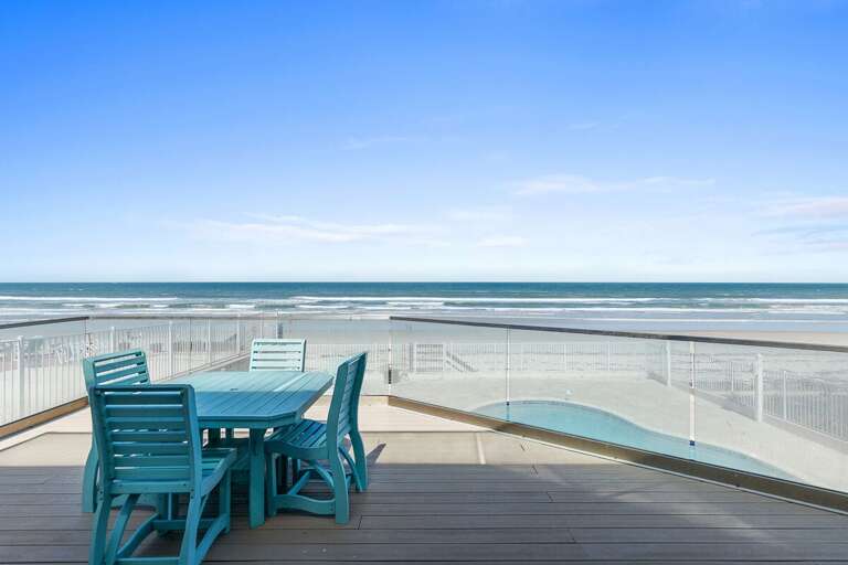 Relax on this spacious oceanfront balcony featuring outdoor dining and sweeping beach views. Perfect for your beach stay, enjoy morning coffee or sunset meals with the sound of waves just steps away.