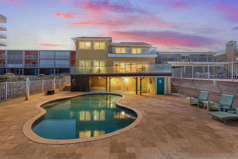 Stunning beach stay retreat featuring a private pool, spacious balconies, and glowing sunset views.