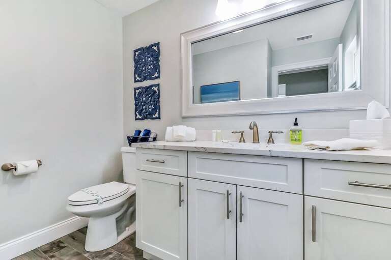 A bright, modern bathroom with beach-inspired décor, spacious vanity, and fresh linens—perfect for refreshing after a day of sun and ocean fun during your beach stay.