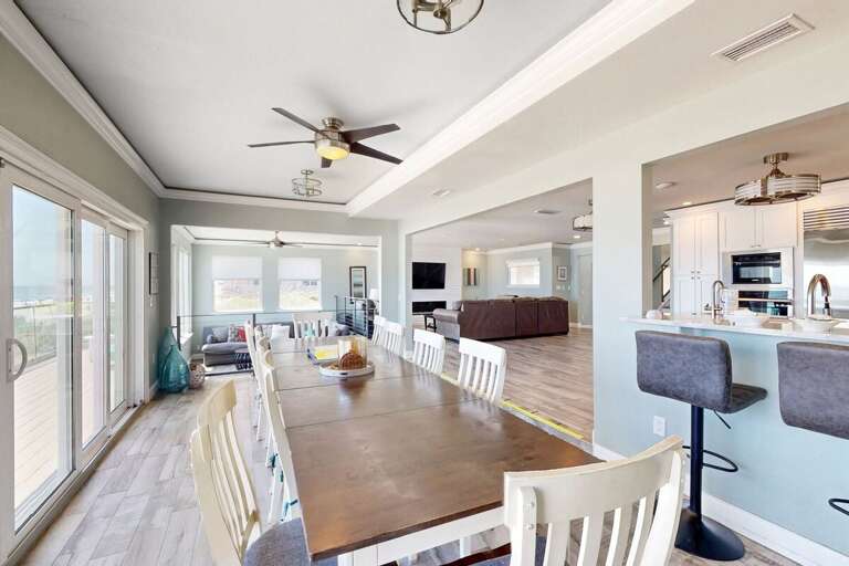 Gather for meals with stunning beach views in this bright, open dining space. Perfect for large groups enjoying a relaxing coastal stay with easy access to the oceanfront deck.