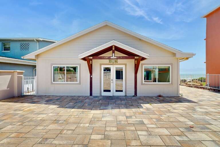 Start your beach stay with a bright, welcoming entrance just steps from the shoreline. This spacious front patio sets the tone for a relaxed coastal getaway.