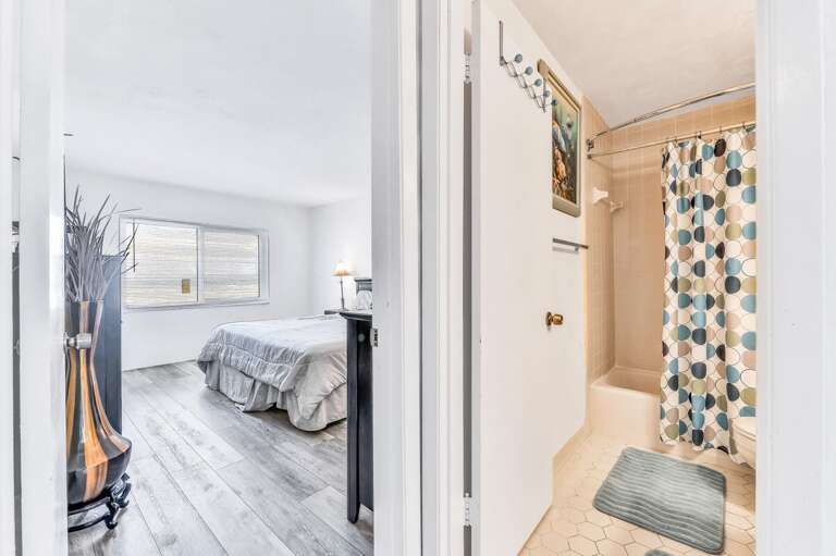 Bright bedroom with an adjoining bath, offering comfort and convenience for your relaxing beach stay. Perfect for unwinding after a day in the sun and surf.