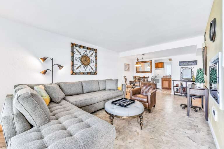Bright, open living area with plush seating and coastal décor—perfect for relaxing after a sun-soaked beach stay. Ideal for family gatherings, dining, and unwinding in comfort.