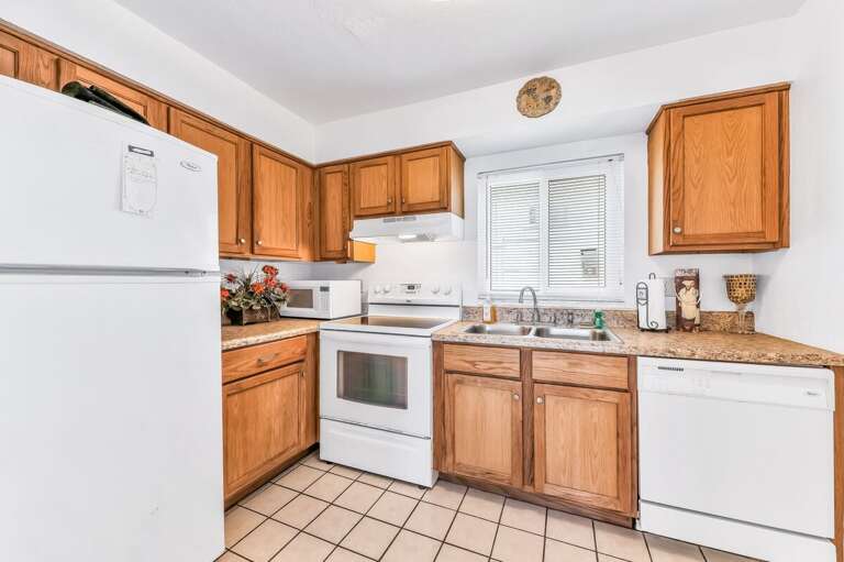 Enjoy this bright, fully equipped kitchen—perfect for preparing snacks and meals during your beach stay. Warm wood cabinets and ample counter space make cooking by the coast simple and convenient.