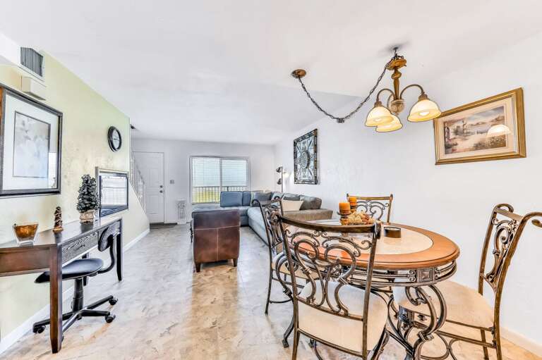 Inviting open-concept living and dining area with stylish décor and plenty of natural light—perfect for relaxing after a fun-filled beach day during your coastal getaway.