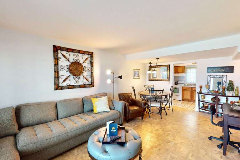 Relax in this inviting open-concept living and dining area, perfect for unwinding after a fun-filled beach stay. Comfortable seating and warm décor create a cozy retreat just steps from the shore.