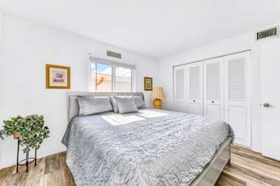 Relax in this serene beach stay bedroom featuring a plush king bed, soft natural light, and calming coastal décor—perfect for unwinding after sun-filled days by the shore.